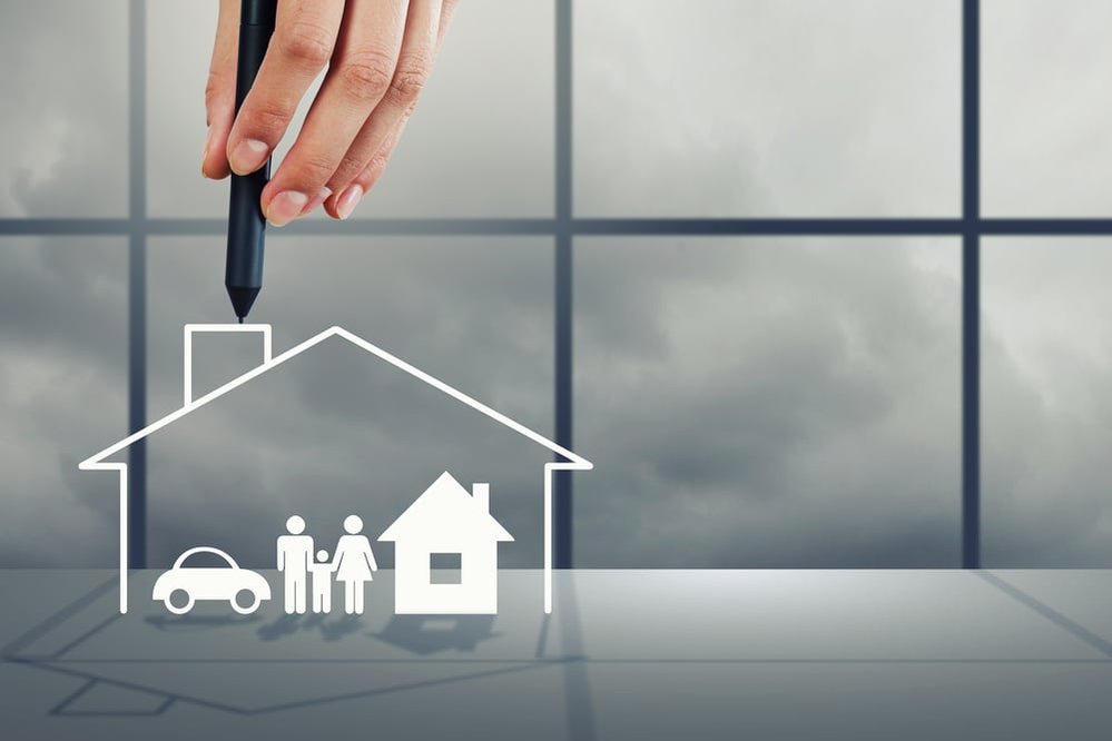 Close up of human hand drawing happy family and real estate concept Close up of human hand drawing happy family and real estate concept